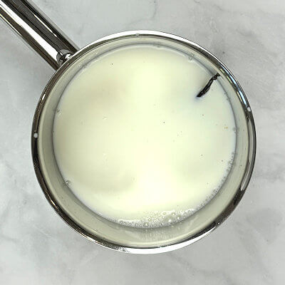 Step 2 - Transfer milk, rice, salt and the split vanilla bean into a heavy saucepan. Bring to a boil, while stirring constantly. This will prevent the rice from sticking to the pan bottom. Reduce the heat to low, cover the pan and simmer gently for about 15 minutes. Stir occasionally.