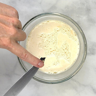 Step 5 - With the back of a knife, scrape the seeds out of the vanilla bean and add to the rice pudding. Pour the pudding back into the pan.