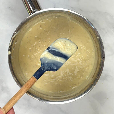 Step 6 - Place the pan over medium-low heat and cook, stirring constantly, until the mixture thickens. This will take about 1-2 minutes and the pudding coats the back of a spoon or spatula.