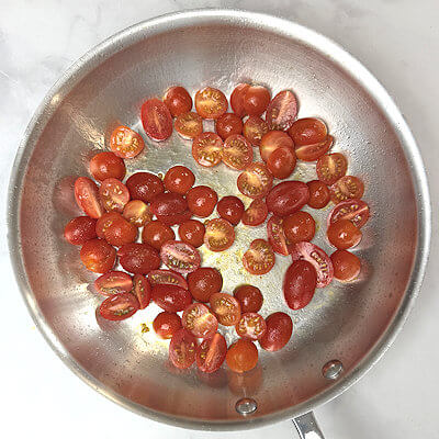Step 1 - Heat olive oil and butter in a skillet and add the cherry tomato halves. Cook on high until the tomatoes burst. Set aside.
