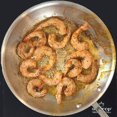 Step 5 - Heat butter in a skillet (the same skillet you used for the tomatoes) and pan-sear the shrimps for a few minutes on each side.