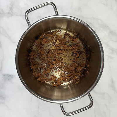 Step 1 - Use a sharp knife and cut a shallow slit lengthwise along the chorizo sausage casing. Heat a pan and add 75% of the chorizo meat and crumble it into small pieces. Transfer cooked meat onto a plate.