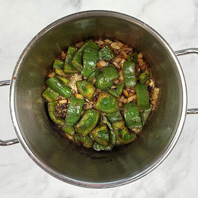 Step 2 - Add olive oil to the pan, add chopped onion and bell pepper and cook until translucent. Add minced garlic, cumin and smoked paprika and stir another minute.