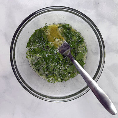 Step 1A - Coarsely chop the spinach. Whisk the eggs with salt and pepper and add the spinach.