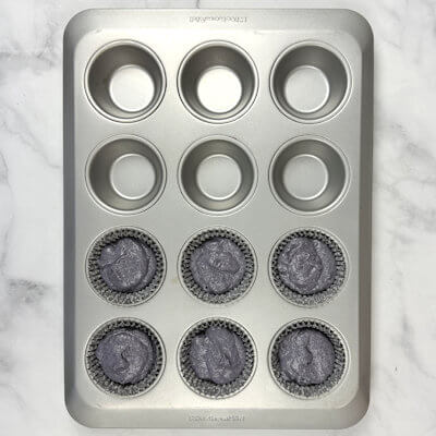 Step 2 - Fill 6 muffin wells with muffin liners.Add the wet ingredients to the dry ingredients and mix until combined, without any dry patches.Use a ice cream scoop and fill 6 muffin liners with the batter.