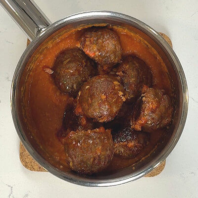 Step 4 - Transfer the meatballs and as much as the juices from the baking sheet to a sauce and keep warm until you serve.