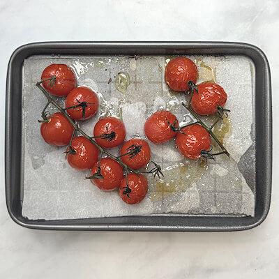 Step 1 - Place cherry tomatoes on a small baking sheet, lined with parchment paper. Drizzle with olive oil and bake in oven of 375 degrees F for about 35 minutes. Set aside
