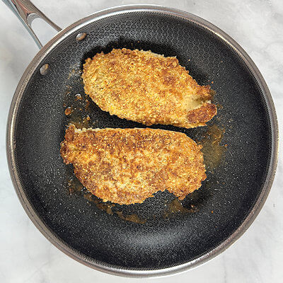 Step 5 - In an oven-proof skillet, heat oil. Add the chicken and saute about 3 minutes on each side or until golden brown and done.