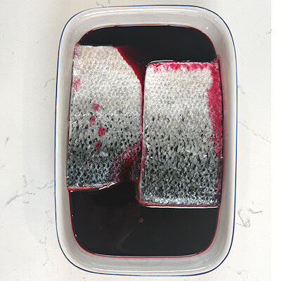 Step 1 - Pour beet juice in a dish and place the salmon fillets, skin-side up in that juice. Make sure the juice is covering the salmon meat. Place the dish in the refrigerator for 1-3 hours.