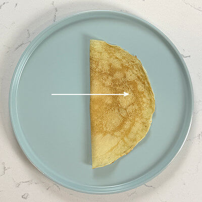 1. The double fold. Fold a crêpe in half. You'll end up with a half circle or a half moon.
