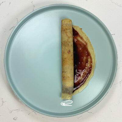 4. The simple roll. Lightly roll the crepes. Don't roll too tight or you'll squeeze the filling out of it.
