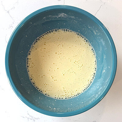 Step 2 - Mix flour and salt. Add the egg mixture, little by little and mix until combined. If you have tiny lumps, you can strain the batter.