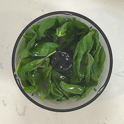 Step 1 - Place garlic, pine nuts, olive oil, salt, basil leaves in a food processor and process until you have a homogeneous mixture that is finely chopped.
