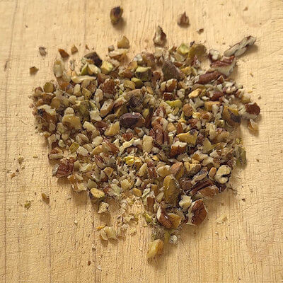 Step 2 - While the couscous is soaking up the milk, chop all the nuts (pecans, walnuts and pistachios). You can do this any way you like, coarsely, finely or a combination.