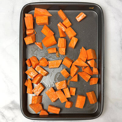 Step 1 - Peel the sweet potato, cut it in cubes of about 1/2-3/4 inch. Drizzle with olive oil and sprinkle with salt & pepper. Make sure all cubes are coated and place them on a baking sheet. Bake in an oven of 425°F for about 30-40 minutes or until the cubes are fork tender.