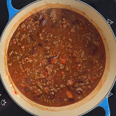 Step 6 - Simmer on low-medium heat and stir once in a while. Cover partly and simmer until the chili has reached the consistency you prefer. This will take a bout 20-30 minutes. Taste and season with salt & pepper if needed.