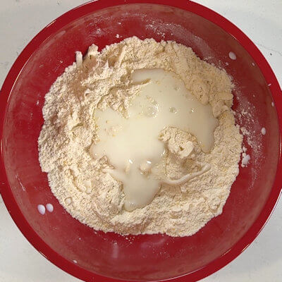 Step 3 - Add the buttermilk and stir until all ingredients are combined. Do not overwork. The dough should still be crumbly, but holding together.