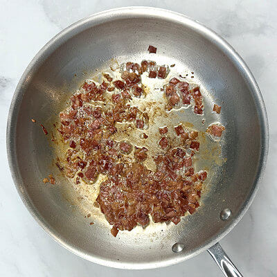 Step 2 - Heat a skillet to medium high and add the pieces of Prosciutto. Stir every now and then, so the ham does not stick to the bottom. You want the Prosciutto to become very crispy (not burned). When it's done, drain it on a paper towel.