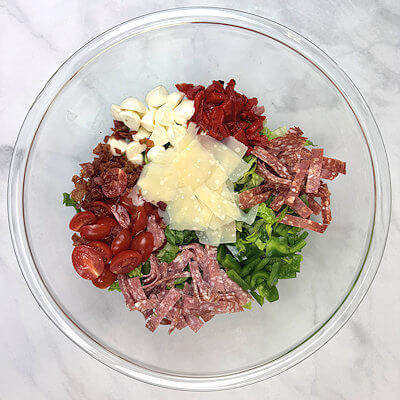 Step 4 - Place the romaine lettuce in the bottom of a large bowl and add all the other chopped ingredients on top.