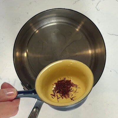Step 1 - Make the saffron oil by mixing olive oil with lemon juice and saffron threads. Warm this mixture for a few minutes, so the saffron threads release their color and aroma.