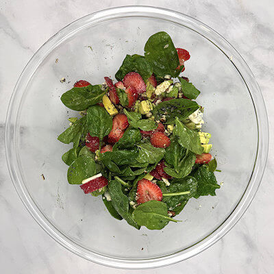 Step 3 - Add the strawberry-avocado mix to the spinach as well as the chopped pecans, and crumbled blue cheese. Toss the salad and divide over 2 plates.