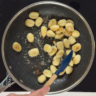 Step 3 - Add some olive oil to the skillet and add the gnocchi. Cook until they are crispy and golden all over, tossing frequently.