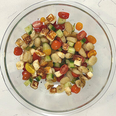 Step 5 - Add the halloumi and gnocchi to the vegetables, and drizzle with a little bit of olive oil. 