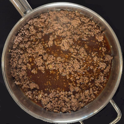Step 4 - Pour the sauce over the ground beef and allow to gently simmer until is slightly thickens.