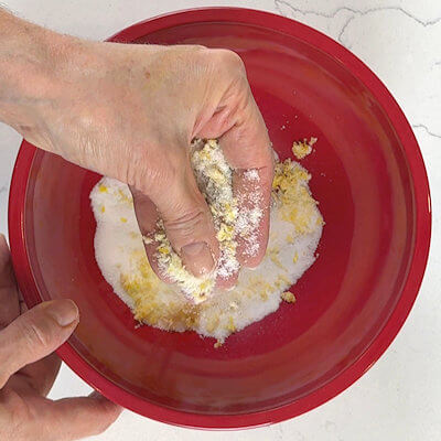 Step 1 - Add granulated sugar and lemon zest to a bowl and rub the zest into the sugar with your fingers. You will smell the release of the essential oils from the lemon zest. This will make the shortbread taste deliciously.