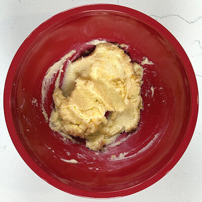 Step 2 - Add the soft butter and vanilla extract and mix this with the sugar, using a spatula. There is no need for a mixer.