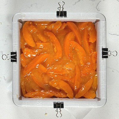 Step 5 - Cut the apricots in thin slices/wedges and combine with sugar, cornstarch, lemon juice and vanilla extract. Mix.Transfer this mixture onto the shortbread bottom and spread evenly.