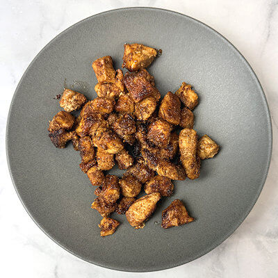 Step 2 - Cut the chicken breast in small cube and season with salt, black pepper, cumin, coriander, chili powder, onion powder, garlic powder, and paprika powder. Heat oil in a skillet and cook the chicken on medium heat for about 5 minutes or until done. Allow to cool a little.