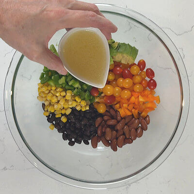 Step 4 - Make the dressing by mixing olive oil, lime juice, honey, salt & pepper. Pour the dressing over the salad and stir.