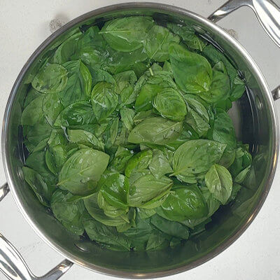 Step 1 – Wash basil leaves and blanch them for about 30 seconds in boiling water.