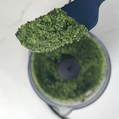 Step 1 - Wash and dry the fresh basil leaves. Transfer the basil leaves and the salt into a food processor and pulse until fine and well mixed.