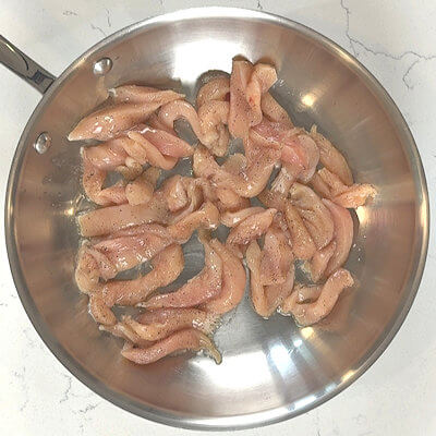 Step 1 - Season strips of chicken breast with salt and pepper. Heat oil in a skillet and sauté the chicken strips until done. Remove from heat and allow to cool.