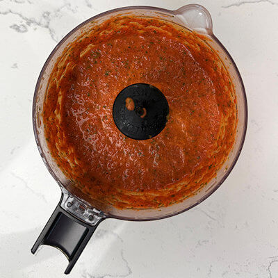 Step 3 - Make the red pepper sauce, by combining all ingredients (roasted red bell peppers, sautéed onion, sautéed garlic, basil, broth, and cream) in a food processor or blender and process until you have a smooth sauce.