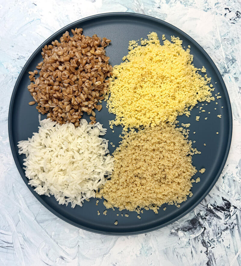 Dark blue plate with cooked grains.