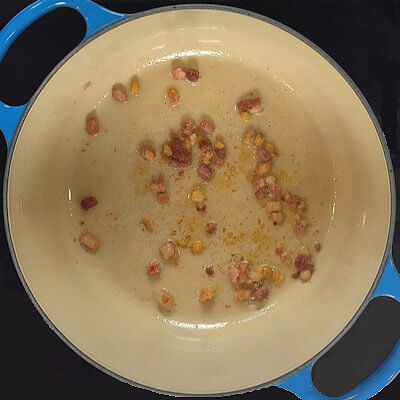 Step 1 - Cook the pancetta in a Dutch oven on low-medium heat and allow all the fat to render. Remove the pancetta from the pan and drain on a paper towel.
