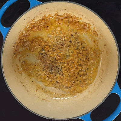 Step 3 - Transfer butter to the Dutch oven and add the finely chopped shallot. Cook for a few minutes until the onion is soft, not crispy.