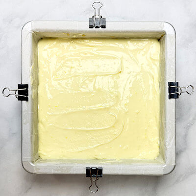 Step 4 - Pour the cheesecake onto the cooled crust and bake it until sides are slightly puffed and center is dry to the touch. This will take about 35 minutes.
