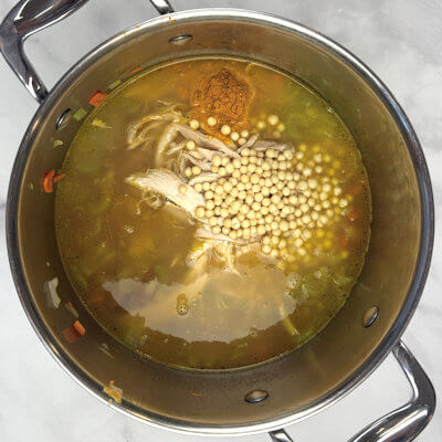 Step 2 - Add the chicken broth, the shredded rotisserie chicken, lemon juice, couscous, turmeric, thyme, oregano, salt & black pepper. Stir to combine and cook for about 15 minutes. This is the time the couscous needs.
